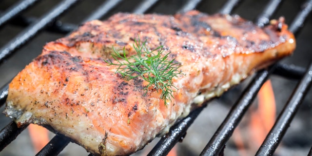 Baked salmon on the grill with fire