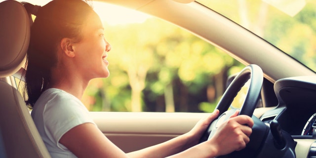 young asian woman driver driving a car,vintage effect