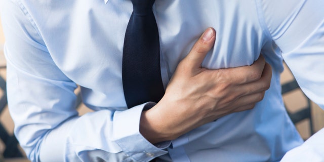 Man in office uniform having heart attack / heart burn