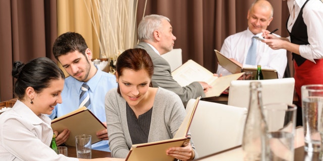 Business lunch executive people looking menu ordering meal at restaurant