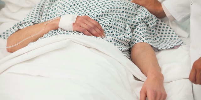 Old sick lady lying in hospital bed