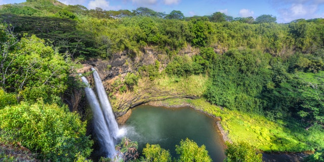 Wailua Falls. The Wailua Waterfall on the island of Kauai flows into the Wailua River. Kauai Island, Hawaii