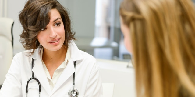 young_woman_doctor_office_istock