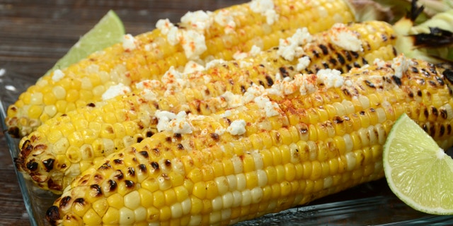 Elote or Mexican grilled corn on the cob served with cotija cheese and chili powder.