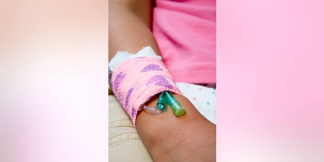 Girl with a catheter in her arm