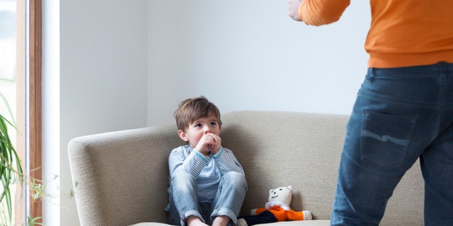 Little boy being shouted at by his dad.