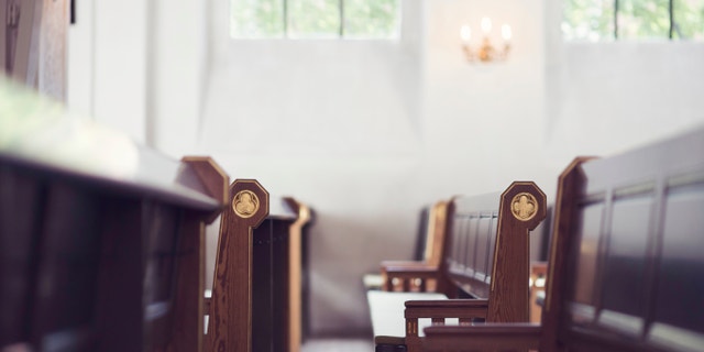 Two rows of benches in a church