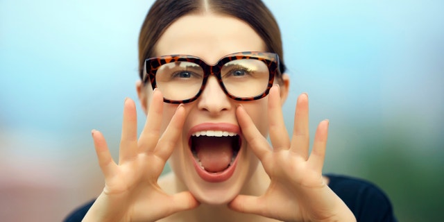 portrait of nerd student with screaming expression, announcing news for you, wearing nerd eyeglasses.