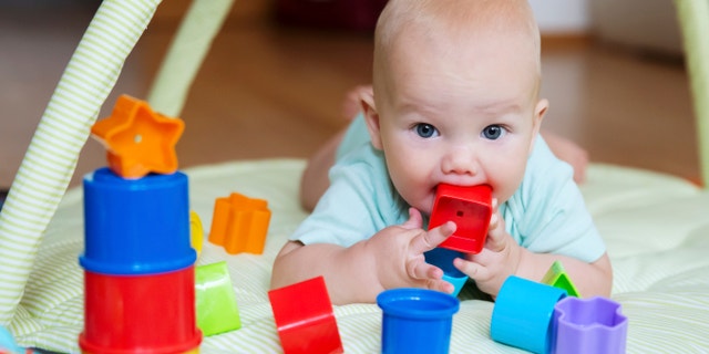 Baby playing with colorful toys