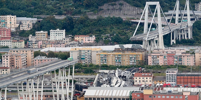 Cars are blocked on the Morandi highway bridge after a section of it collapsed, in Genoa, northern Italy, Tuesday, Aug. 14, 2018.