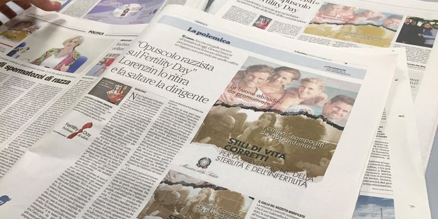 A journalist lays out newspapers reporting the Italian Health Ministry's "Fertility Day" campaign ad showing four light-skinned adults at the beach illustrating "good habits" for reproductive health, over a group of young people, including a black man, smoking, in Rome, Thursday, Sept. 22, 2016. Italy's efforts to combat infertility and reverse one of Europe's lowest birthrates have stumbled with an ad campaign denounced as sexist, racist and ignorant of the economic reasons why Italians aren't having babies. The ad was removed by the ministry after being denounced as racist.