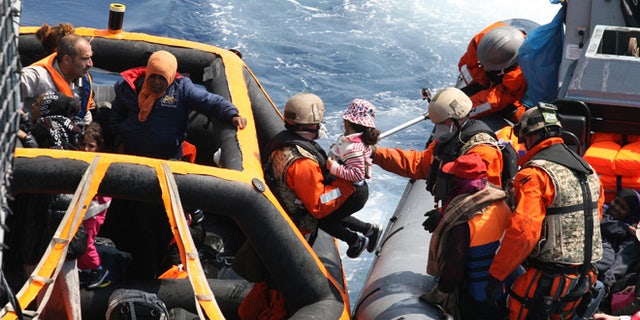 June 6, 2015: photo provided by German Bundeswehr, soldiers of the German frigate 'Hesse' rescue refugees in the Mediterranean Sea.