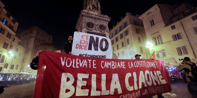 Anti-referendum militants gather in downtown Rome after Italian Premier Matteo Renzi conceded defeat in a constitutional referendum and announced he will resign in Rome, early Monday, Dec. 5, 2016.