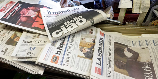 Newspaper headlines show Italian Premier Matteo Renzi's resignation following the result of Sunday's constitutional referendum, at a newsstand in Rome, Monday, Dec. 5, 2016. Italian voters dealt Premier Renzi a resounding rebuke early Monday by rejecting his proposed constitutional reforms, plunging Europe's fourth-largest economy into political and economic uncertainty. (AP Photo/Gregorio Borgia)