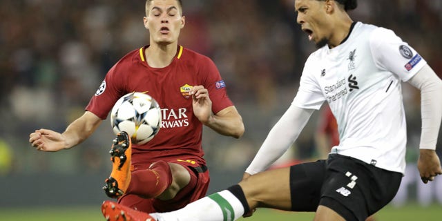 AS Roma's Patrik Schick, left, vies for the ball with Liverpool's Virgil Van Dijk during a UEFA Champions League semifinal second leg soccer match in Rome, May 2, 2018.