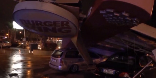 A large Burger King sign fell onto cars after a tornado tore through the Italian city of Caserta.