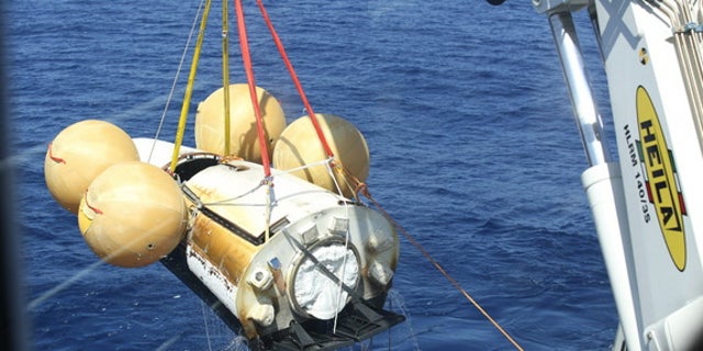 Europe's Intermediate eXperimental Vehicle robotic space plane is pulled out of the ocean after its first test flight on Feb. 11, 2015. European Space Agency officials are already planning the spacecraft's next test.