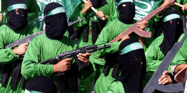 In this Oct. 24, 2003, file photo, Palestinian masked Hamas terrorists march during a protest rally at Jabaliya refugee camp in the Gaza Strip.