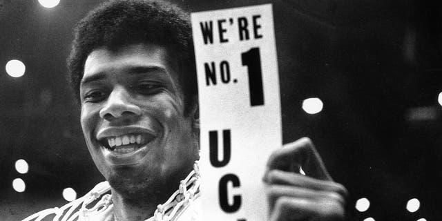 UCLA's Lew Alcindor holds a sign just after leading UCLA to the NCAA basketball championship in Los Angeles on March 23, 1968. Alcindor boycotted the 1968 Summer Olympics. After winning his first NBA championship in 1971, he took the Muslim name Kareem Abdul-Jabbar.