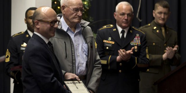 Guillaume Lacroix, l., consul general of France in Chicago, presented French Legion of Honor to 98-year-old Jack Baker, a former Army private first class who fought in World War II, at a ceremony in Olive Hill, Ky.