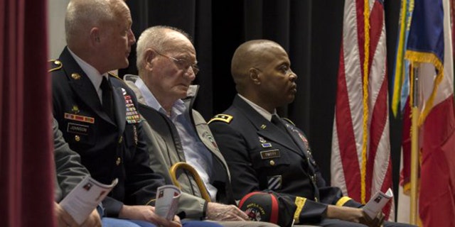 98-year-old Jack Baker, c., a private first class who served with the First United States Army during World War II, was recognized for his service during a ceremony in his hometown of Olive Hill, Ky., Wednesday.