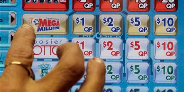 A clerk prepares to operate a lottery machine to print out Mega Millions lottery tickets for a customer at Tobacco Plus, Tuesday, Dec. 17, 2013, in Muncie, Ind. With tickets selling well, the jackpot for tonight's drawing is now at an estimated $636 million, the second-biggest lottery prize in U.S. history. (AP Photo/Darron Cummings)