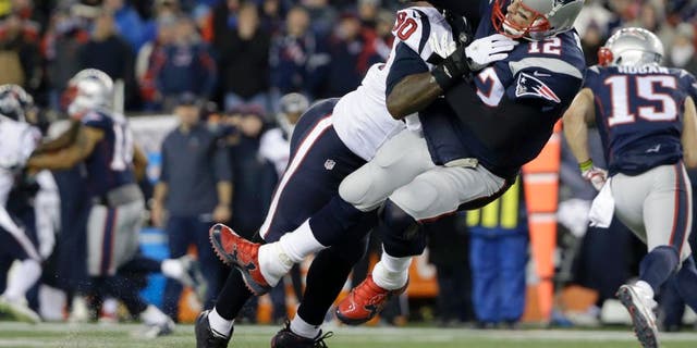 Houston Texans defensive end Jadeveon Clowney (90) levels New England Patriots quarterback Tom Brady (12) after Brady released a pass during the first half of an NFL divisional playoff football game, Saturday, Jan. 14, 2017, in Foxborough, Mass. (AP Photo/Elise Amendola)