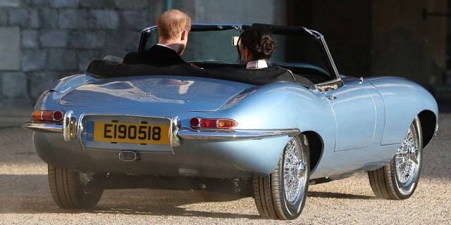 The newly married Duke and Duchess of Sussex, Meghan Markle and Prince Harry, leave Windsor Castle in a convertible car after their wedding in Windsor, England, to attend an evening reception at Frogmore House, hosted by the Prince of Wales, Saturday, May 19, 2018. (Steve Parsons/pool photo via AP)