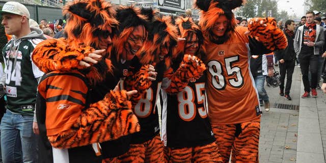 Jaguars fans stand arm-in-arm before an NFL game in London.