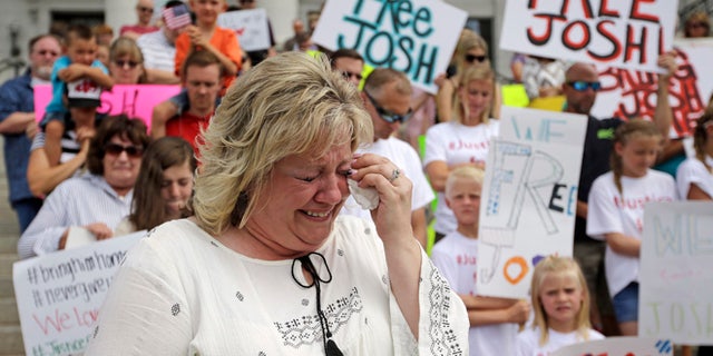 FILE - In this July 30, 2016, file photo, Laurie Holt, the mother of Joshua Holt, an American jailed in Venezuela, cries during a rally at the Utah State Capitol, in Salt Lake City.