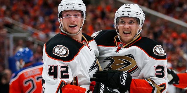 Anaheim Ducks' Jakob Silfverberg, right, from Sweden, celebrates his goal with teammate Josh Manson during the third period of Game 3 in a second-round NHL hockey Stanley Cup playoff series against the Edmonton Oilers in Edmonton, Alberta, Sunday, April 30, 2017. (Jeff McIntosh/The Canadian Press via AP)
