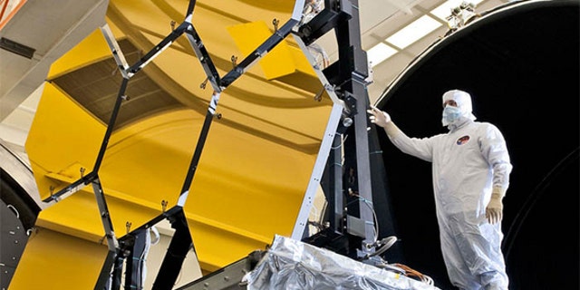 An engineer inspects the JWST's primary mirror segments at NASA's Marshall Space Flight Center in Huntsville,