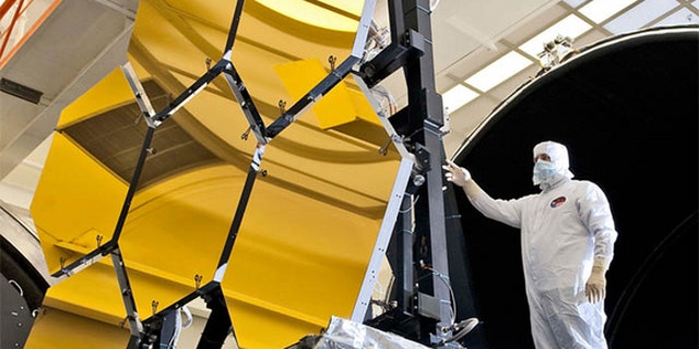 An engineer inspects the JWST's primary mirror segments at NASA's Marshall Space Flight Center in Huntsville,