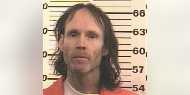 A police booking photo from the 2000s shows James Hogue.