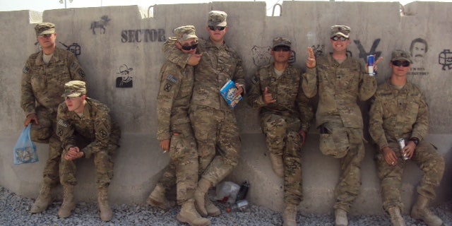 James (second from left) poses for a photo with SPC Douglas J. Jeffries Jr. (third from left) who later died