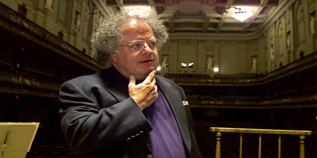James Levine was accused of sexually harassing a minor by a former music student. Here Levine stands at the conductor's podium at Boston's Symphony Hall in 2001. 