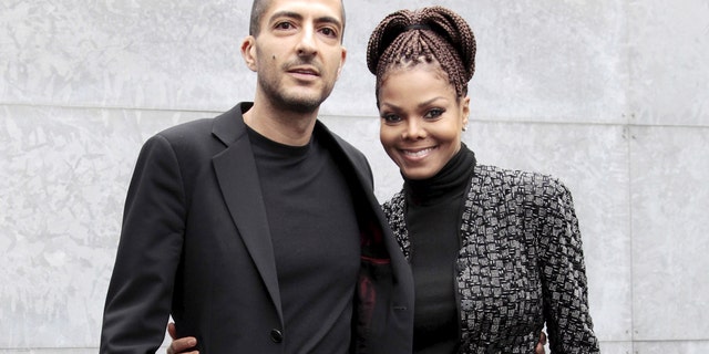 U.S. singer Janet Jackson (R) and her then boyfriend Wissam Al Mana pose for photographers as they arrive to attend the Giorgio Armani Autumn/Winter 2013 collection at Milan Fashion Week, February 25, 2013. REUTERS/Alessandro Garofalo/File Photo - RTSRYVN