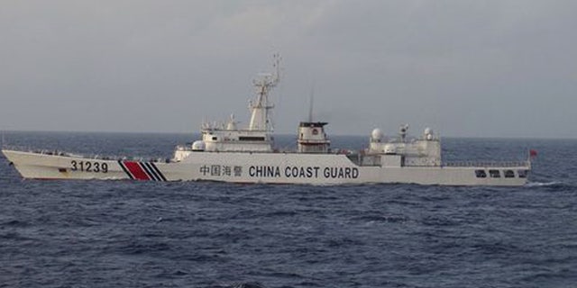 An armed Chinese coast guard ship sails in the water off islands claimed by Japan and China, on Tuesday.(Photo: Japan Coast Guard via AP)
