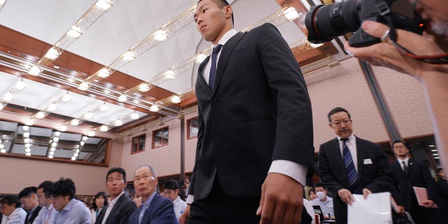 Nihon University's American football player Taisuke Miyagawa arrives for a news conference.
