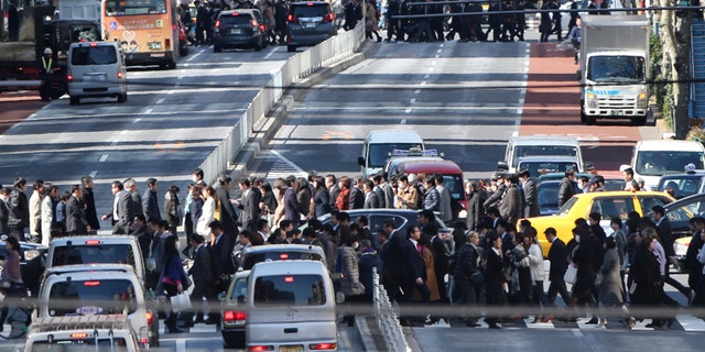 Feb. 26, 2016: People cross crosswalks on a street in Tokyo.