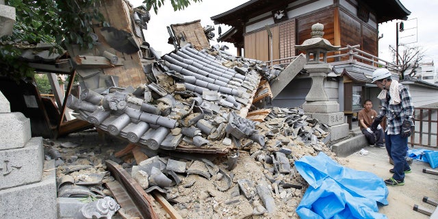 The gate of Myotoku-ji temple is shown after it collapsed following an earthquake in Ibaraki City, Osaka, western Japan, June 18, 2018.