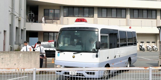 A police vehicle carrying Yoshitane Yamasaki leaves Sanda Police Station on Monday.