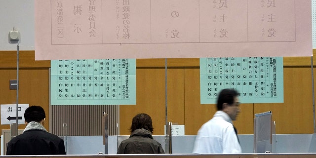 Voter fill their ballots in a general election at a polling station in Tokyo Sunday, Oct. 22, 2017