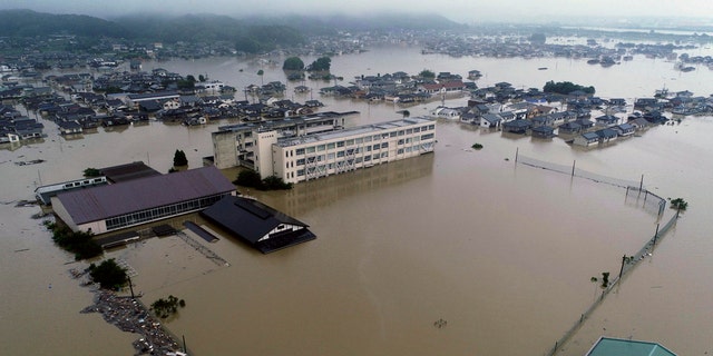 The compound of a junior high school is flooded after heavy rains in Kurashiki, Okayama prefecture, southwestern Japan, Saturday, July 7, 2018.