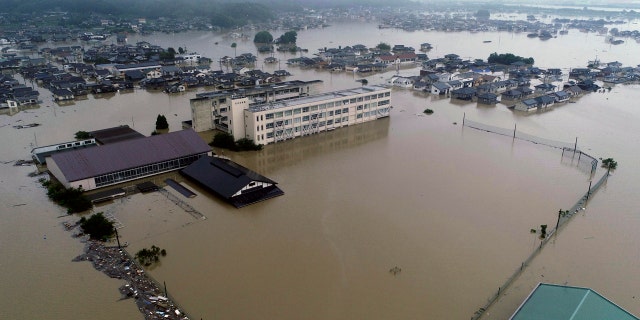 The compound of a junior high school is flooded after heavy rains in Kurashiki, Okayama prefecture, southwestern Japan, Saturday, July 7, 2018.