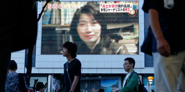 Aug. 21, 2012: An image of Japanese journalist Mika Yamamoto is shown on a large monitor screen in Tokyo during a TV news broadcast reporting her death in Syria.