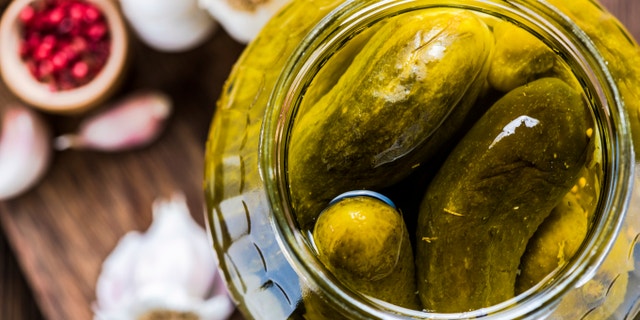 Pickled gherkins in jar, fermented food with spices