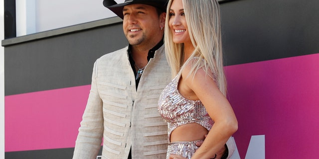 Jason Aldean (left) and his wife Brittany Kerr arrive at the 52nd Academy of Country Music Awards in Las Vegas, Nevada, April 2, 2017.