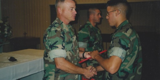 Jason Arwine (right), who served in the U.S. Marines from 1997 to 2005, shakes Lt. Col. Wilkinson's hand at the Marine Corps Air Station in Yuma, Arizona. Arwine was diagnosed with Parkinson's disease in October 2012 and participated in the Parkinson Voice Project about two years ago.