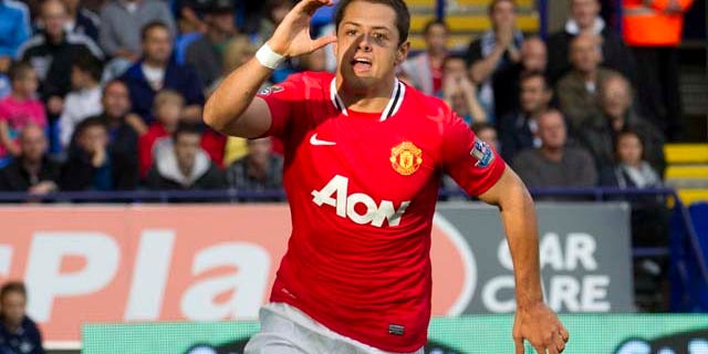 Manchester United's Javier Hernandez celebrates after scoring against Bolton during their English Premier League soccer match at The Reebok Stadium, Bolton, England, Saturday Sept. 10, 2011. (AP Photo/Jon Super)